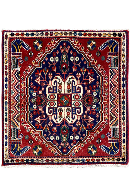 Square Oriental rug with a red field, blue central medallion, and border frame