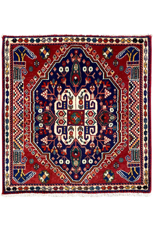 Square Oriental rug with a red field, blue central medallion, and border frame