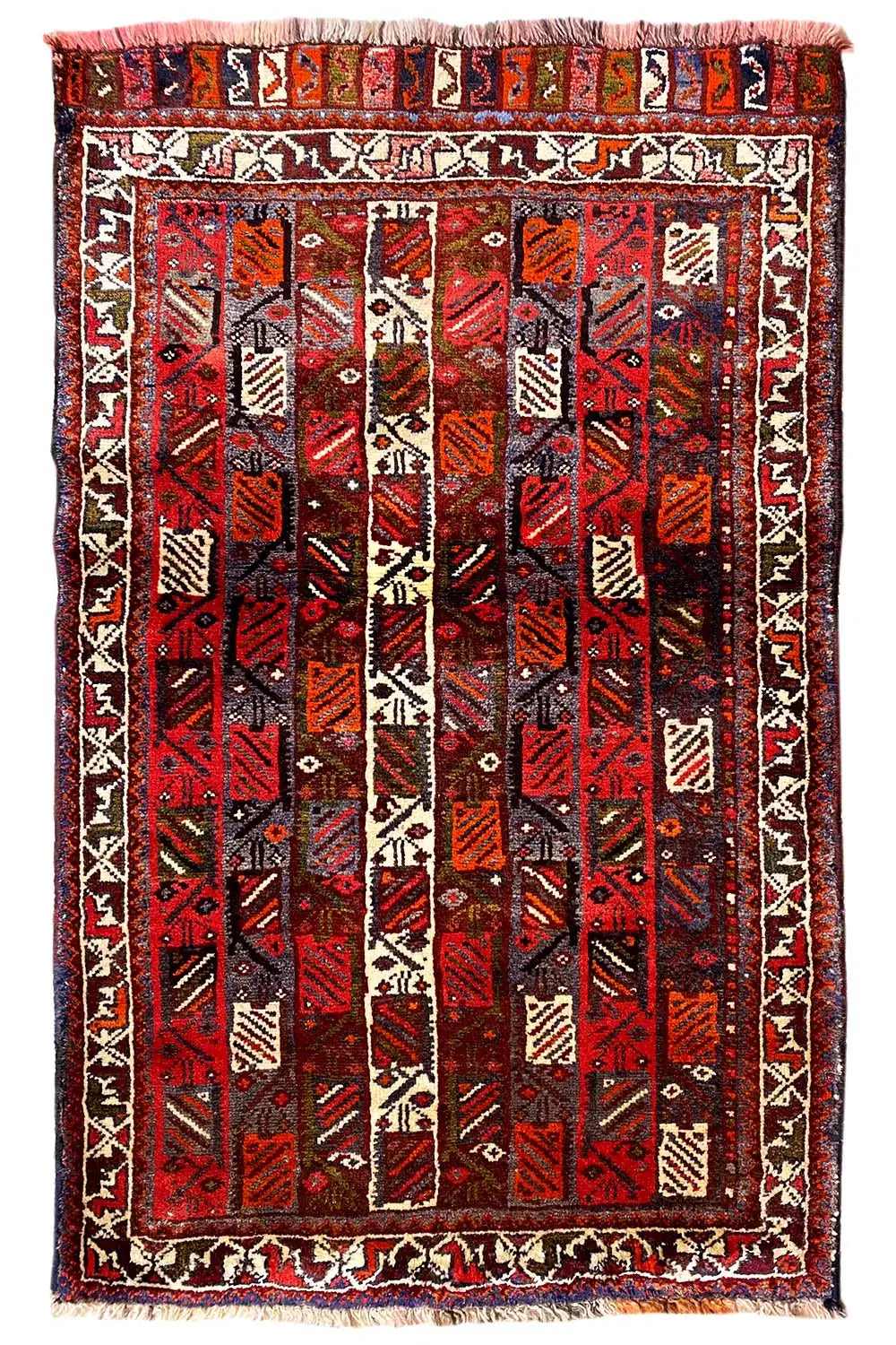 Rug with a red center and black pattern, beige border with decorative stripes