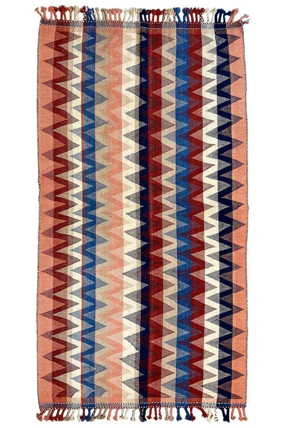 Rug with zigzag stripes in brown, blue, and cream, with fringes on all sides
