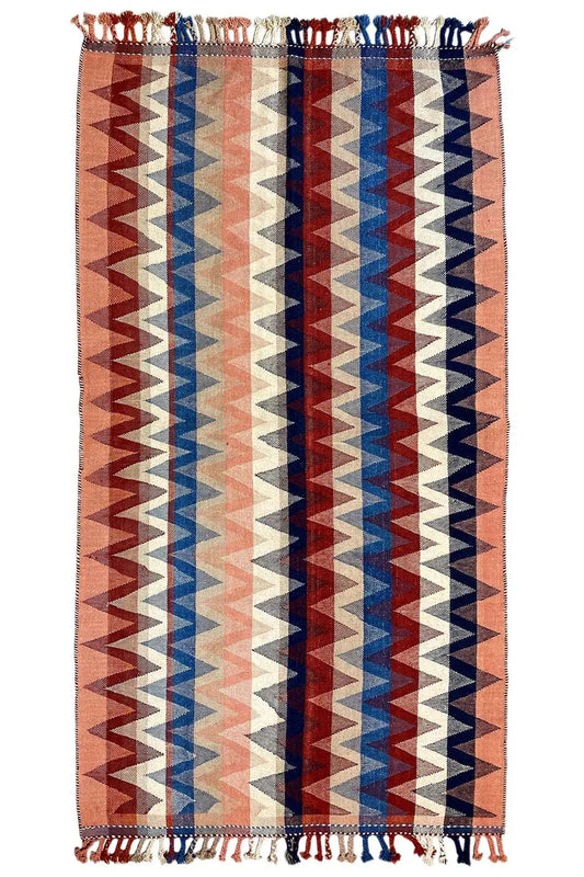 Rug with zigzag stripes in brown, blue, and cream, with fringes on all sides