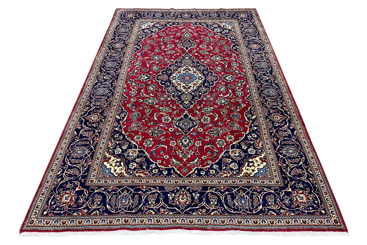 Keshan rug, rectangular: red medallion field with blue ornamental border