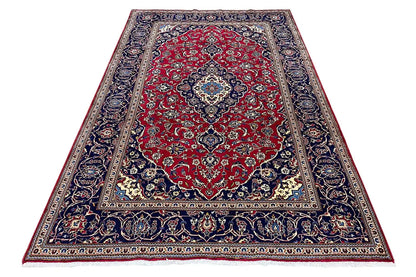 Keshan rug, rectangular: red medallion field with blue ornamental border