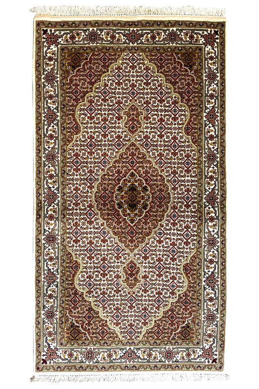 Indo Tabriz rug: rectangular, dark red-brown medallion with a white vine pattern.