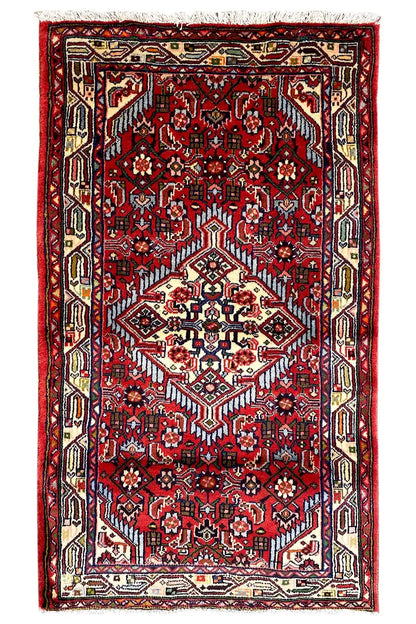 Portrait-format Hamadan rug: red pattern with a cream-colored medallion and border