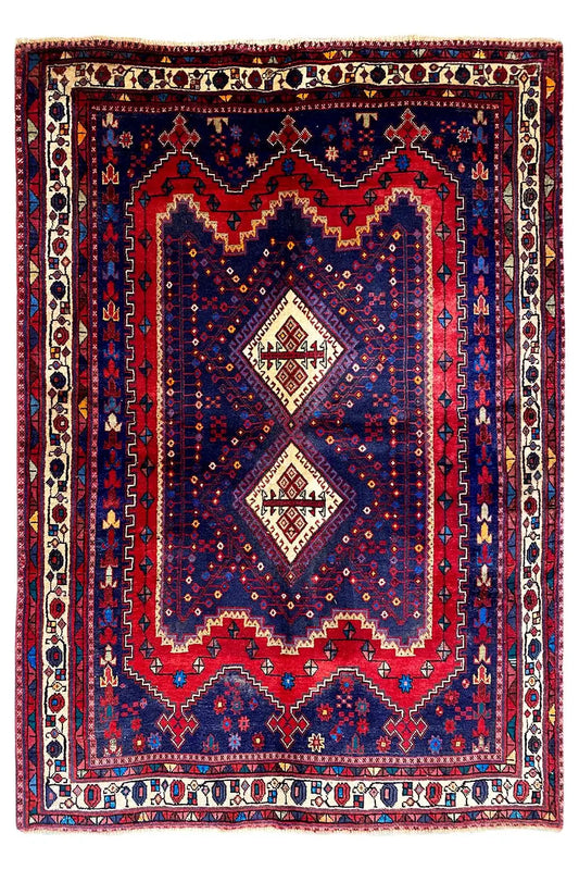 Sirjan rug with a symmetrical central medallion and multicolored border trim