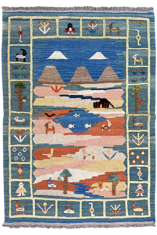 Kilim rug shown straight on, slightly offset: blue, red and beige with a figural border and fringes