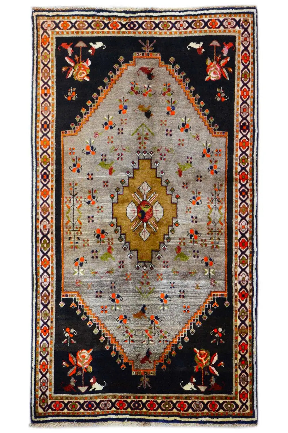 Rug with a black base, beige center field, and gold medallion, floral ornaments
