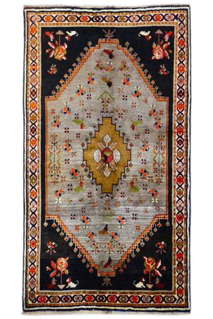Rug with a black base, beige center field, and gold medallion, floral ornaments