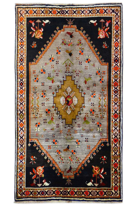 Rug with a black base, beige center field, and gold medallion, floral ornaments