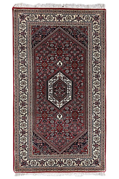 Bidjar rug, rectangular, dark red with medallion and fringe