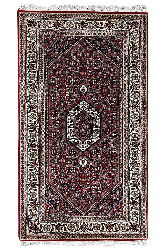 Bidjar rug, rectangular, dark red with medallion and fringe