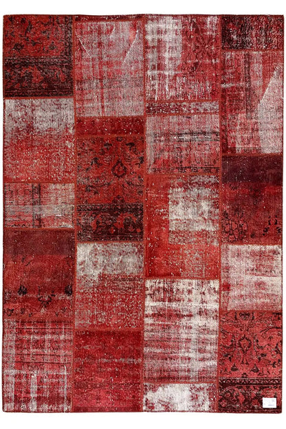 Rectangular patchwork rug, red and white, with varied patchwork pieces and ornamental inserts