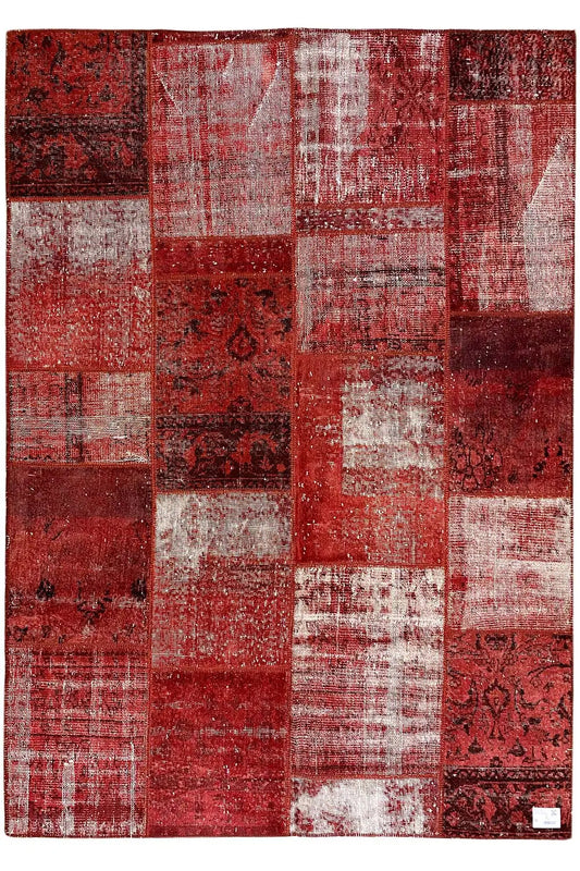 Rectangular patchwork rug, red and white, with varied patchwork pieces and ornamental inserts
