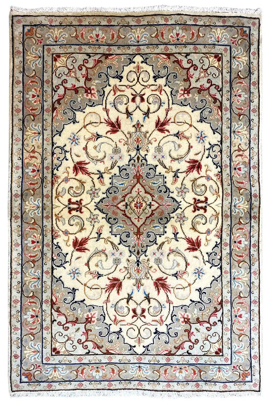 Beige Oriental rug with a central medallion, blue border, and red floral details