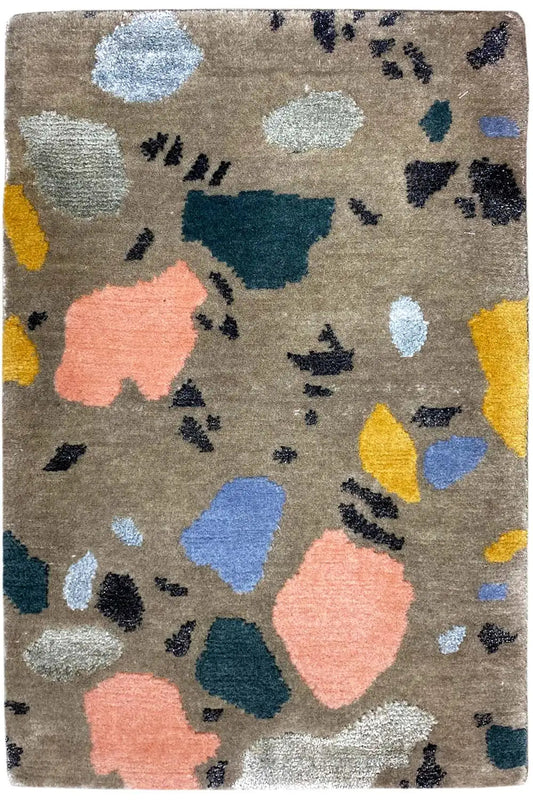 Beige designer rug with colorful abstract spots and a dark pattern, square