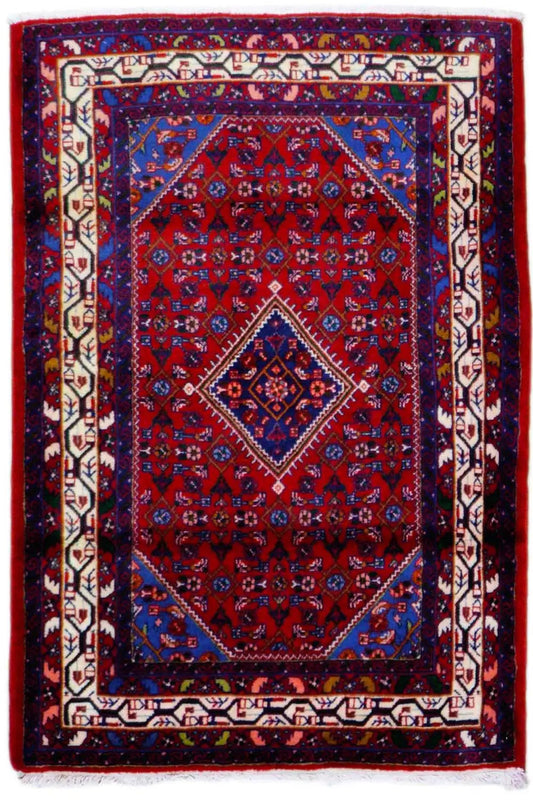 Dark red Oriental rug with a blue border, red medallion, and white edging, rectangular