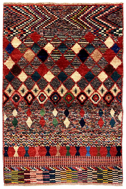 Multicolored rug with diamond border and fringe; red, blue, green in the pattern