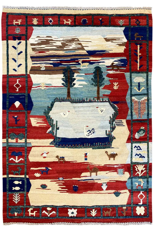 Kilim Qashqai rug with a red frame, blue border band, and landscape motif in the center
