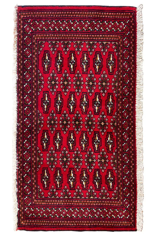 Turkmen carpet 110x51 cm with a dark red field, decorative border and light fringes