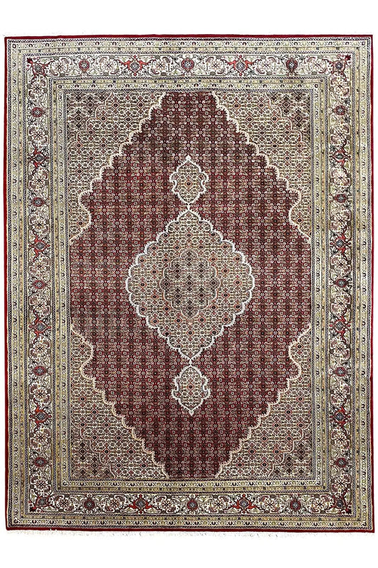 Indo Tabriz rug with a red central field, border, and medallion motifs