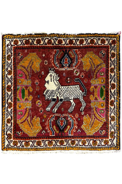 Rug with a red central motif, white horse, and wide ornamental border