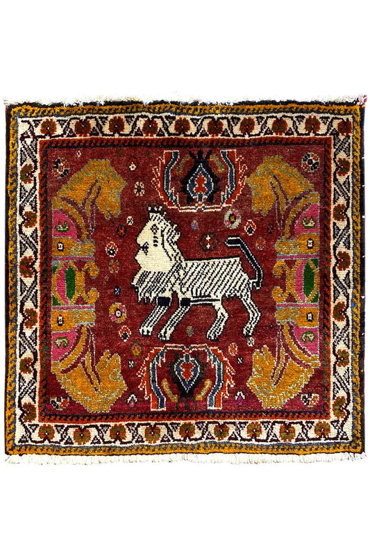 Rug with a red central motif, white horse, and wide ornamental border