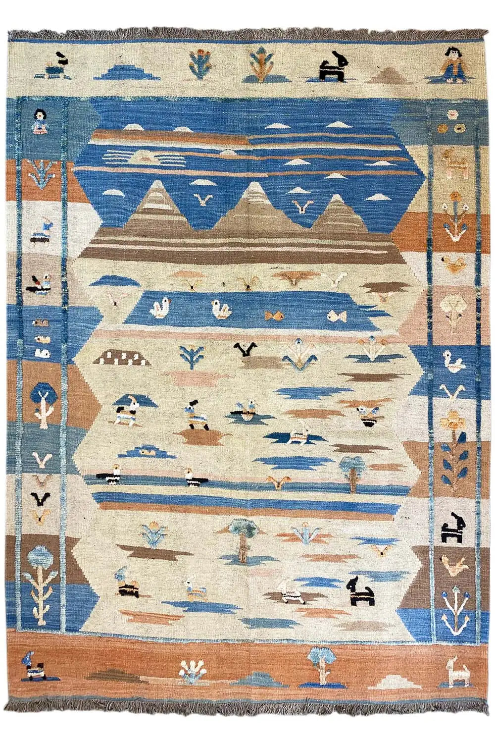 Rectangular kilim rug with a blue and beige geometric pattern, finished with fringes all around