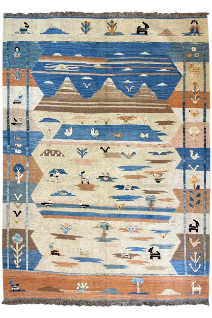 Rectangular kilim rug with a blue and beige geometric pattern, finished with fringes all around