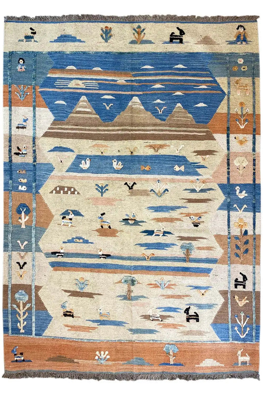 Rectangular kilim rug with a blue and beige geometric pattern, finished with fringes all around