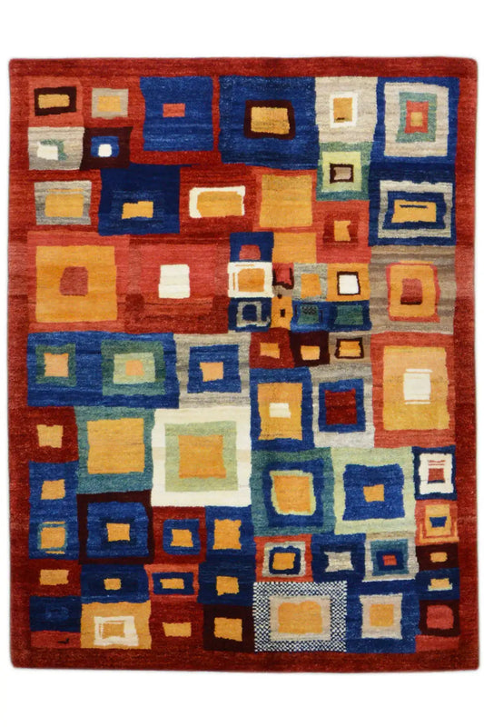 Gabbeh rug front view with a geometric tile pattern in red, blue, yellow, and cream