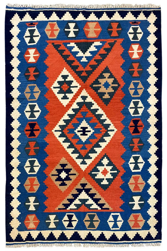 Kilim rug with a central diamond pattern and border in blue, red, and cream