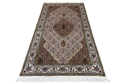 Indo Tabriz rug: narrow rectangular rug with medallion and ornamental border.