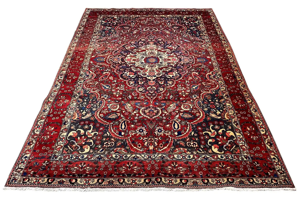 Red floral rug with a dark pattern and a wide decorative border