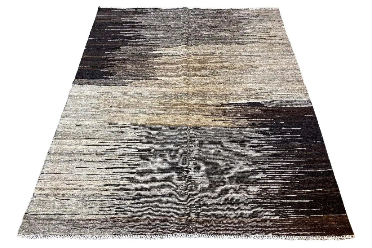 Kilim rug, trapezoidal with gray and beige stripes as well as dark areas.
