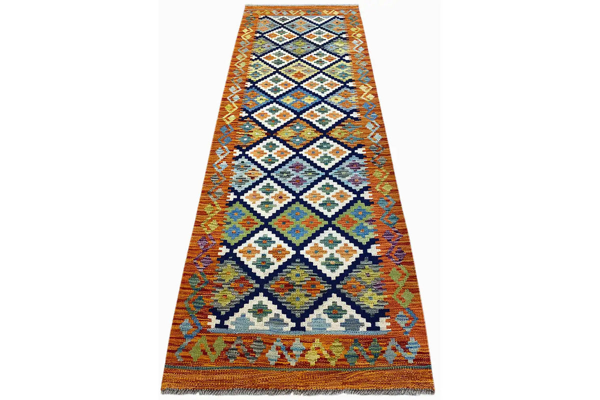 Afghan kilim runner laid flat, orange zigzag and diamond pattern