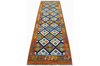 Afghan kilim runner laid flat, orange zigzag and diamond pattern