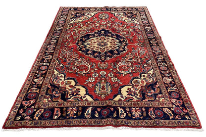 Carpet with a red central field, blue vine and medallion pattern, and bound edges