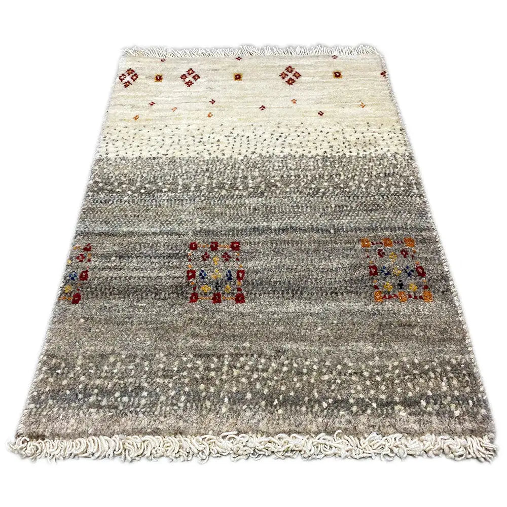 Gabbeh rug with a beige background, gray stripes, colorful decorative motifs, and a fringed edge