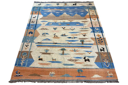 Rectangular kilim rug with patterns in blue, beige, and brown, with fringe