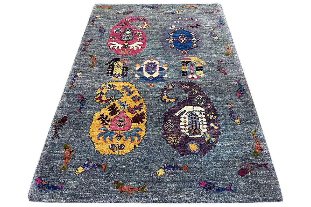 Gabbeh Lori rug in three-quarter view, blue-gray with colorful medallions