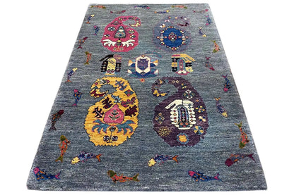 Gabbeh Lori rug in three-quarter view, blue-gray with colorful medallions