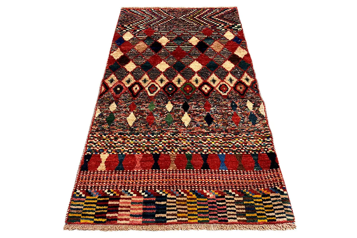 Rectangular rug with a geometric diamond and border pattern; colorful fringes