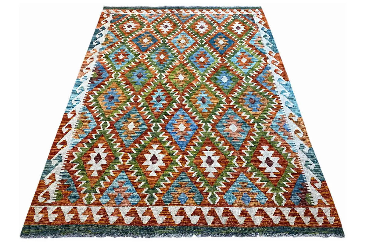 Rectangular kilim rug with colorful patterns and fringes along the edge