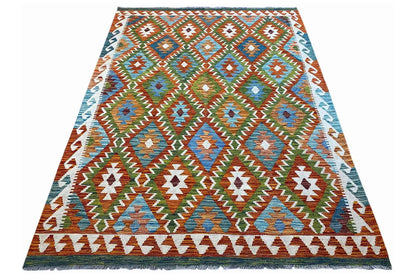 Rectangular kilim rug with colorful patterns and fringes along the edge