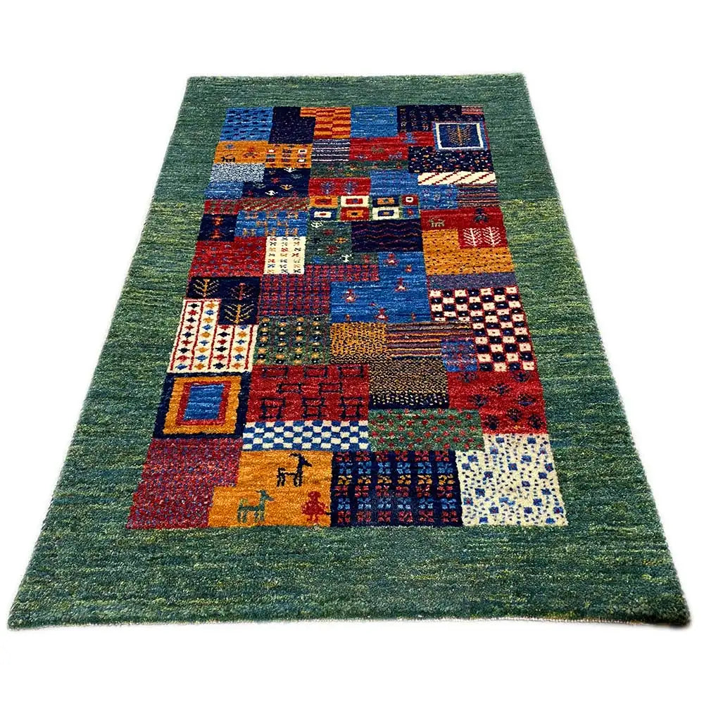 Gabbeh rug 96x60 cm with a green background and colorful patchwork pattern