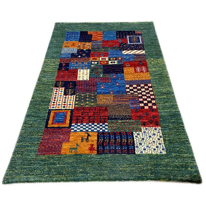 Gabbeh rug 96x60 cm with a green background and colorful patchwork pattern