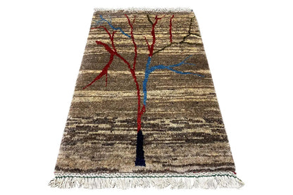 Rug with a centered red-and-blue tree ornament, brown-and-beige striped pattern, and fringes