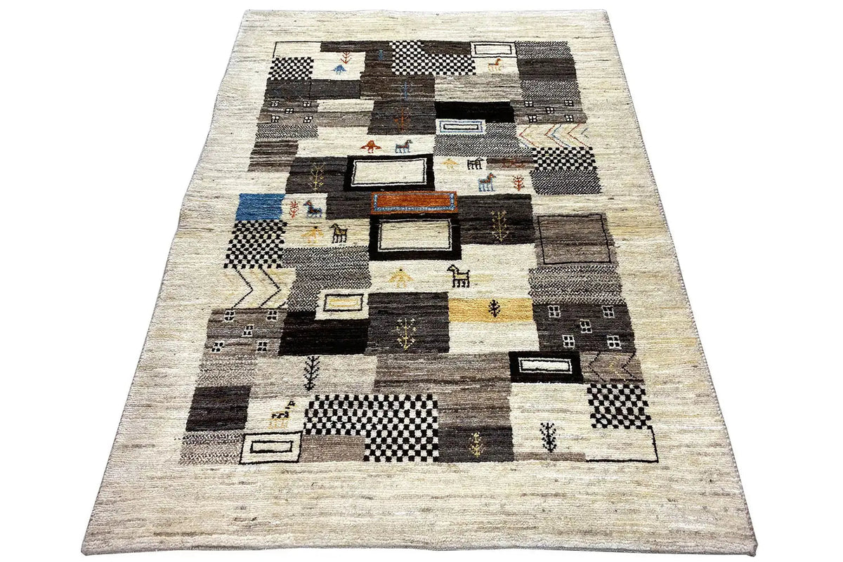 Gabbeh rug with a patchwork of light, black, and gray squares