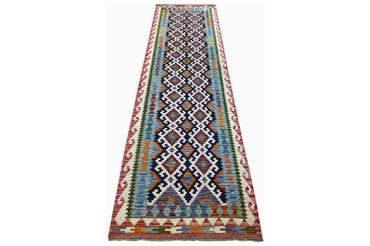 Kilim runner spread diagonally with geometric ornaments and a colorful border